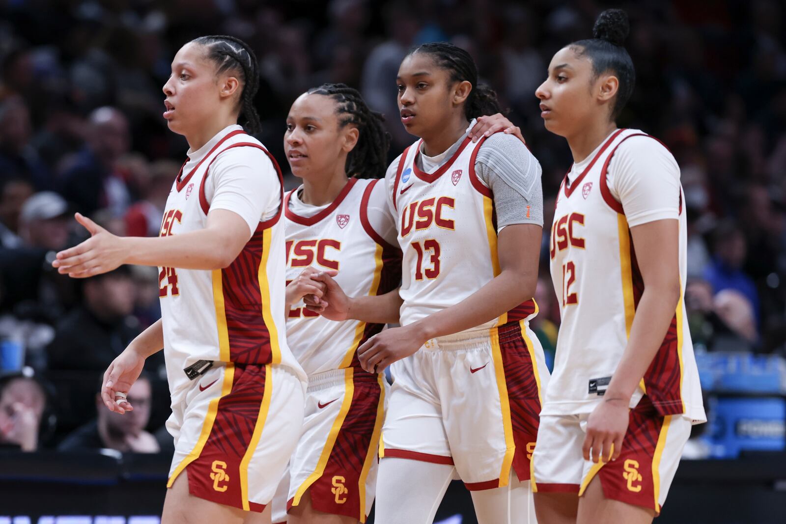 FILE - Southern California players Kaitlyn Davis, left, McKenzie Forbes, second from left, Rayah Marshall (13) and JuJu Watkins react after a Sweet 16 college basketball game against Baylor in the women's NCAA Tournament, March 30, 2024, in Portland, Ore. (AP Photo/Howard Lao, File)