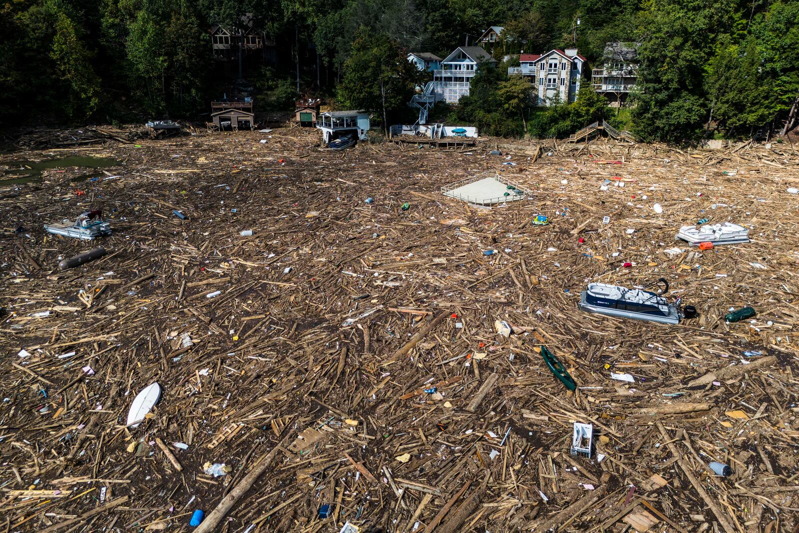 Debris is strewn on the lake in the aftermath of Hurricane Helene, Wednesday, Oct. 2, 2024, in Lake Lure, N.C. (AP Photo/Mike Stewart)