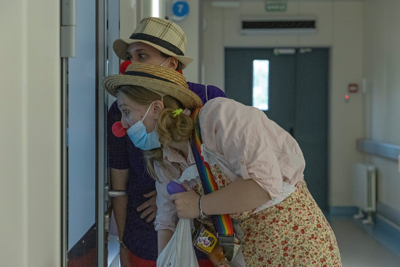 Vladyslava Kulinich, rear, and Tetiana Nosova, who have the clown names Lala and Zhuzha, prepare to perform at Okhmatdyt children's hospital in Kyiv, Ukraine, Thursday Sept. 19, 2024. (AP Photo/Anton Shtuka)