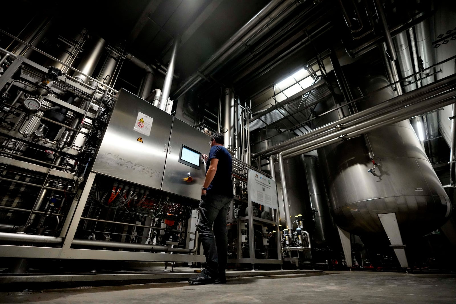 Head Brewmaster Tobias Zollo checks the output at the Weihenstephan brewery in Freising, Germany, Friday, Sept. 20, 2024. (AP Photo/Matthias Schrader)