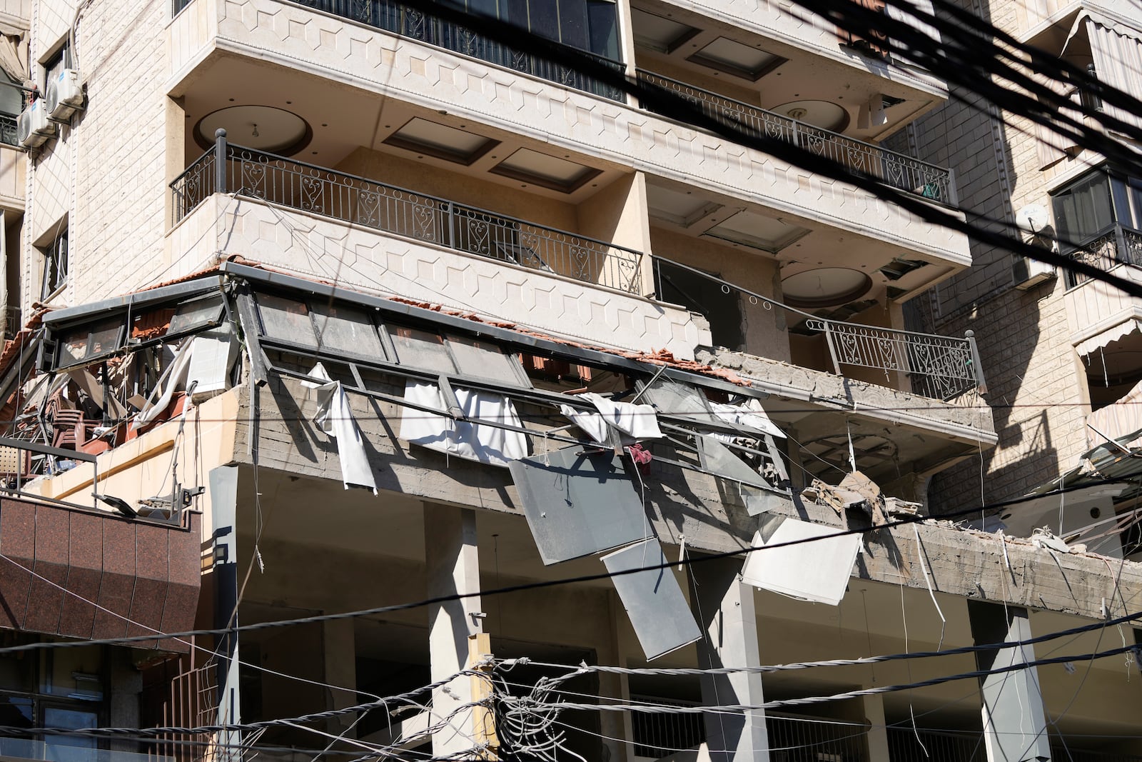 A damaged building at the site of an Israeli airstrike in Beirut's southern suburbs, Thursday, Sept. 26, 2024. (AP Photo/Hassan Ammar)