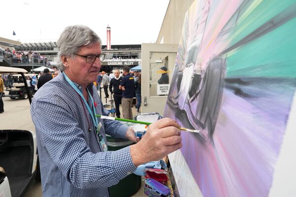 Artist William Patterson paints in Gasoline Alley before the start of the Indianapolis 500 auto race at Indianapolis Motor Speedway in Indianapolis, Sunday, May 25, 2025. (AP Photo/AJ Mast)