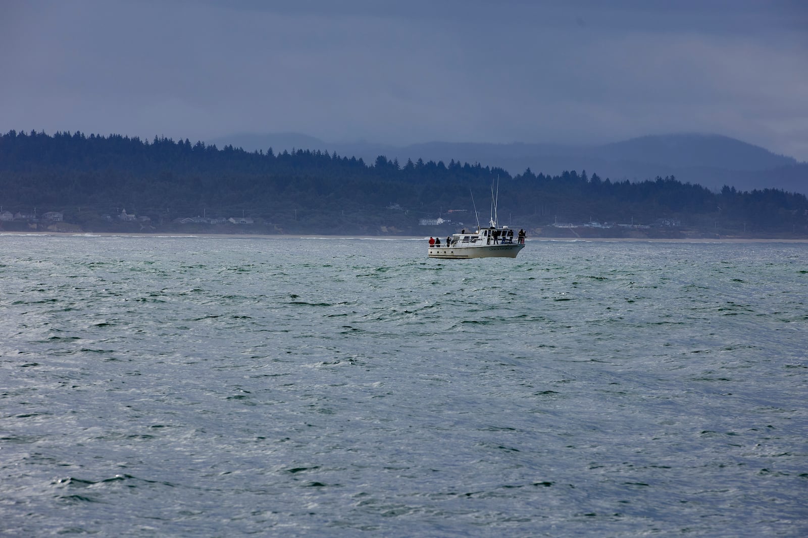 Fishermen fish in the Pacific Ocean near the wave energy test site in Newport, Ore., Friday, Aug. 23, 2024, where private developers will be able to test devices that they've designed to harness energy from waves. (AP Photo/Craig Mitchelldyer)