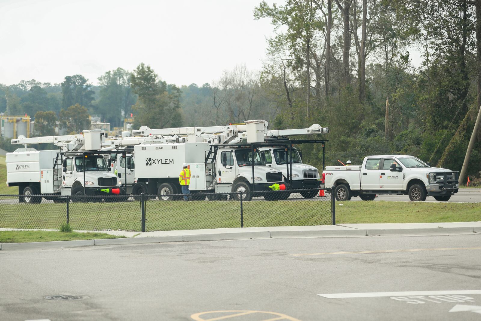 Crew members from Xylem Tree Experts gather at a staging area at Langley Pond Park in the aftermath of Hurricane Helene Sunday, Sept. 29, 2024, in Aiken, S.C. (AP Photo/Artie Walker Jr.)