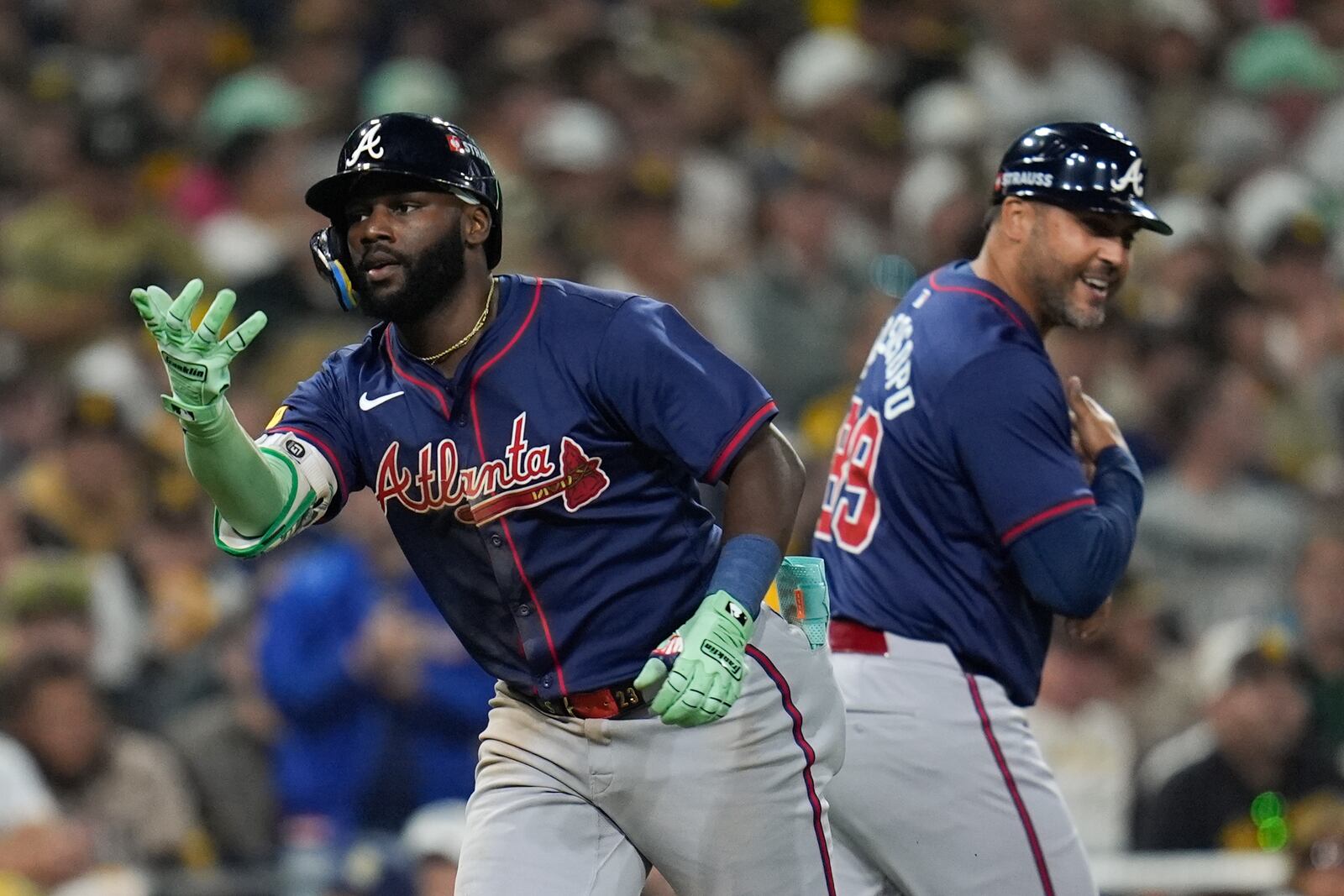 Atlanta Braves' Michael Harris II, left, celebrates with third base coach Matt Tuiasosopo after hitting a two-run home run during the eighth inning in Game 2 of an NL Wild Card Series baseball game against the San Diego Padres, Wednesday, Oct. 2, 2024, in San Diego. (AP Photo/Gregory Bull)