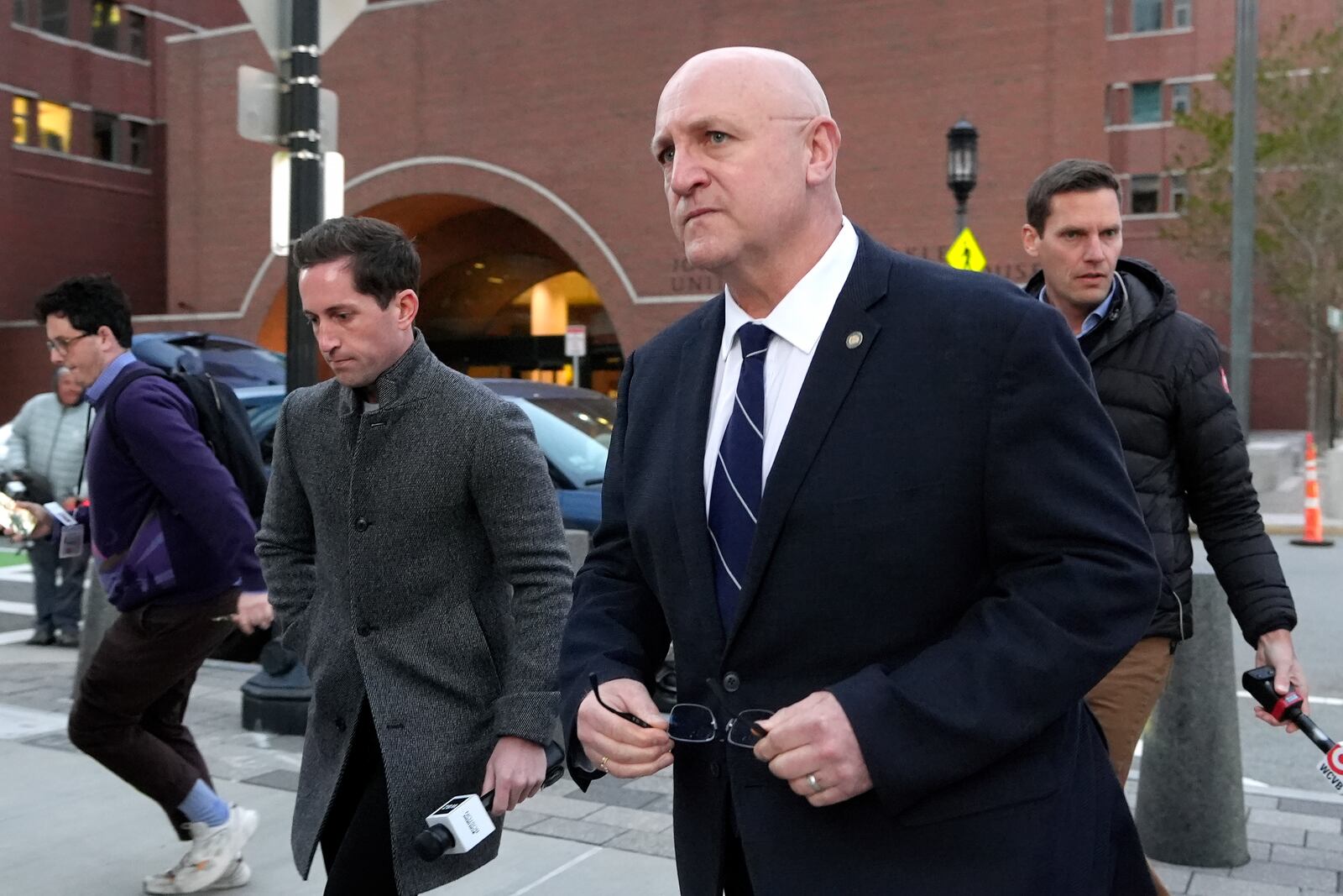 Thomas Dufault, center right, stepfather of Massachusetts Air National Guardsman Jack Teixeira, departs federal court, Tuesday, Nov. 12, 2024, in Boston, following a sentencing hearing for Jack Teixeira. (AP Photo/Steven Senne)