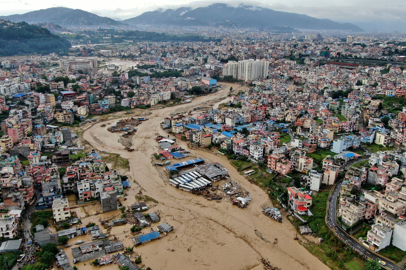 In this aerial image of the Kathmandu valley, Bagmati River is seen in flood due to heavy rains in Kathmandu, Nepal, Saturday, Sept. 28, 2024. (AP Photo/Gopen Rai)