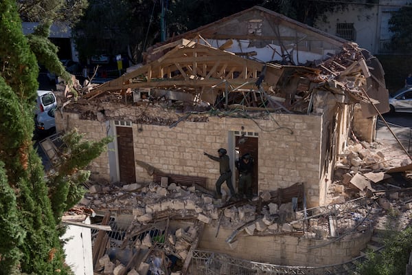 Israeli security forces check a house hit by a rocket fired from Lebanon on Saturday, in Haifa, Israel, Sunday, Nov. 17, 2024. (AP Photo/Ohad Zwigenberg)