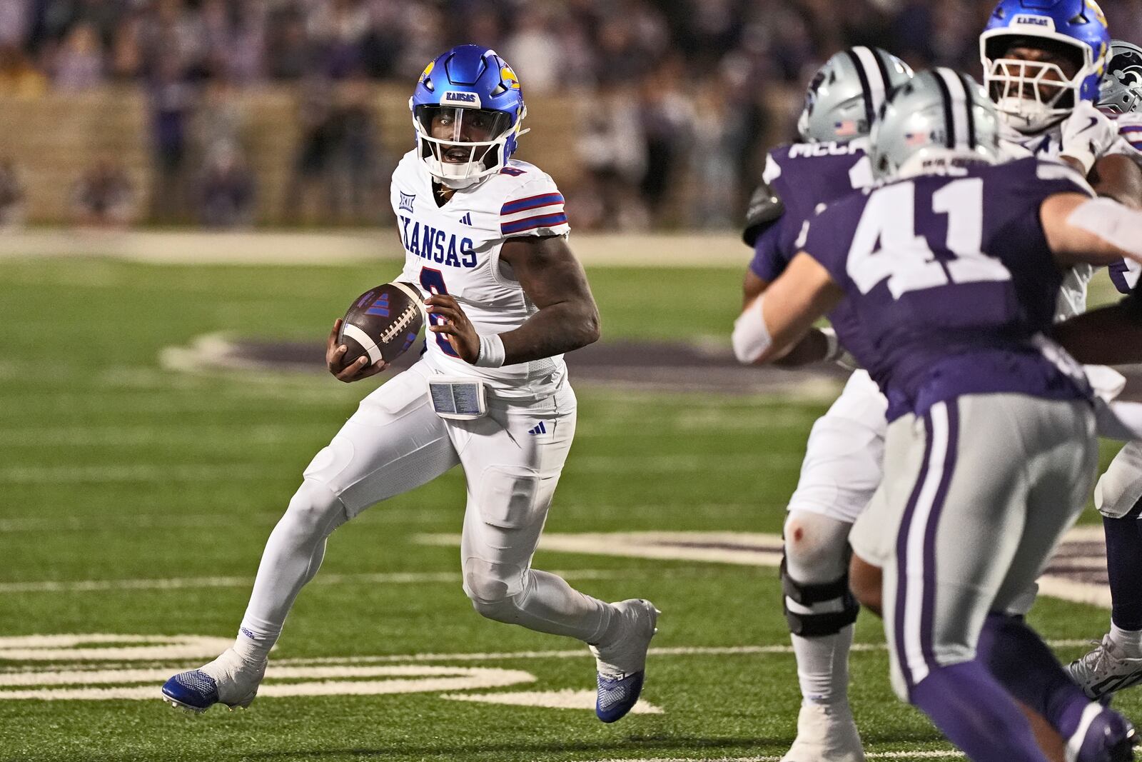 Kansas quarterback Jalon Daniels (6) runs the ball during the first half of an NCAA college football game against Kansas State Saturday, Oct. 26, 2024, in Manhattan, Kan. (AP Photo/Charlie Riedel)