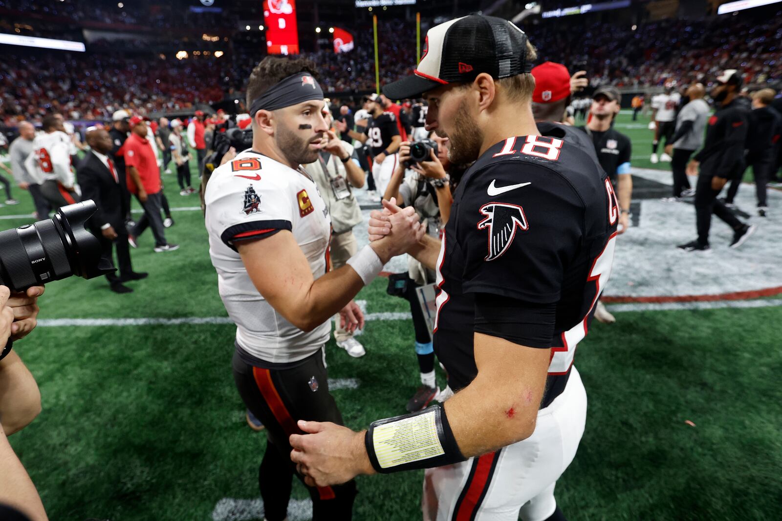 Atlanta Falcons quarterback Kirk Cousins (18) shakes hands with Tampa Bay Buccaneers quarterback Baker Mayfield after the Falcons defeated the Buccaneers during overtime in an NFL football game Friday, Oct. 4, 2024, in Atlanta. (AP Photo/Butch Dill)