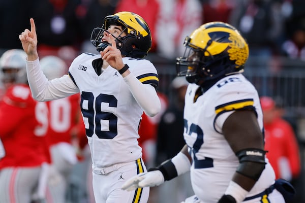 Michigan kicker Dominic Zvada, left, celebrates making the game-winning field goal against Ohio State during the second half of an NCAA college football game Saturday, Nov. 30, 2024, in Columbus, Ohio. (AP Photo/Jay LaPrete)