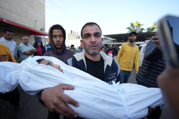 A Palestinian mourns a child, one of of nine people killed in an Israeli strike in Bureij refugee camp, Gaza Strip, Friday, Nov. 15, 2024. (AP Photo/Abdel Kareem Hana)