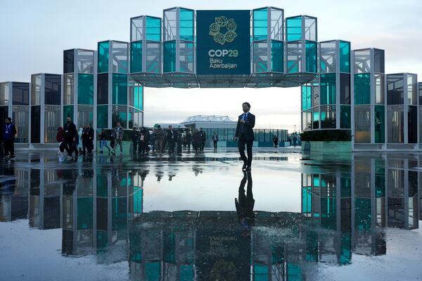 Attendees arrive for the day at the COP29 U.N. Climate Summit, Thursday, Nov. 14, 2024, in Baku, Azerbaijan. (AP Photo/Rafiq Maqbool)