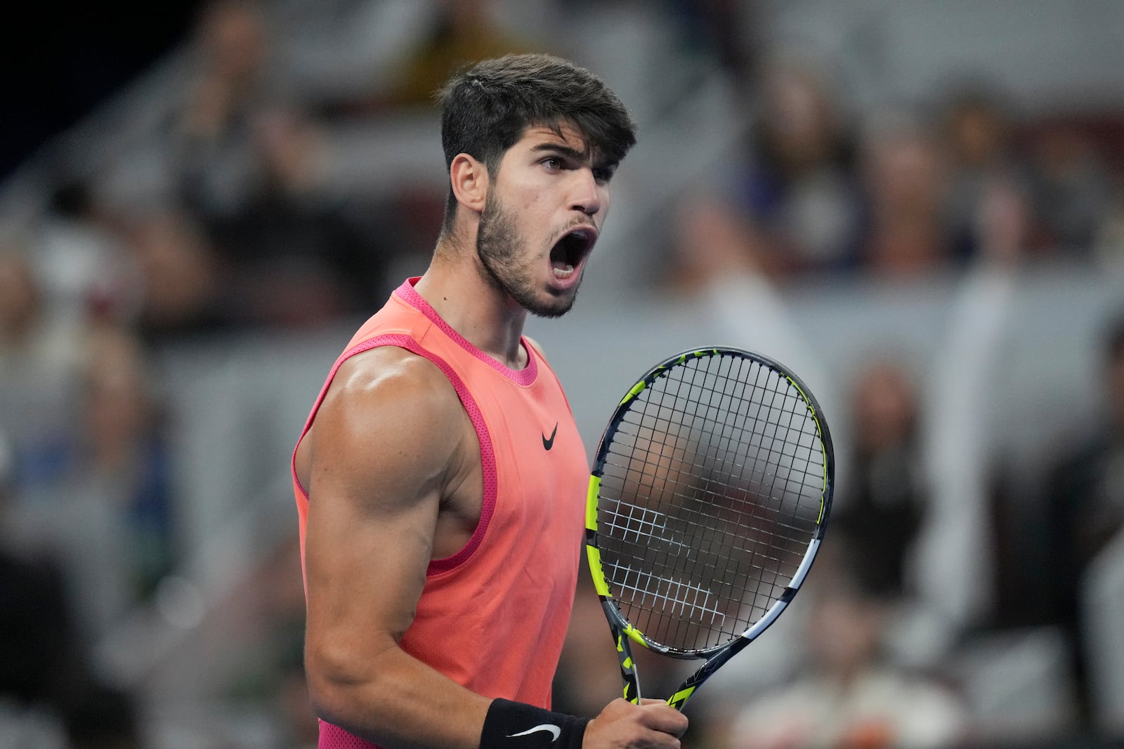 Carlos Alcaraz of Spain reacts during their men's singles finals match against Jannik Sinner of Italy at the China Open tennis tournament, National Tennis Center in Beijing, Wednesday, Oct. 2, 2024. (AP Photo/Achmad Ibrahim)