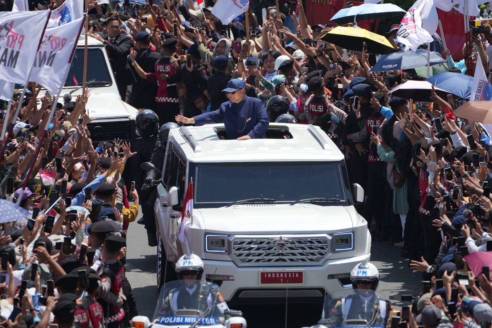 Newly-inaugurated Indonesian President Prabowo Subianto, center, greets supporters after being sworn in as the country's eighth president in Jakarta, Indonesia, Sunday, Oct. 20, 2024. (AP Photo/Dita Alangkara)