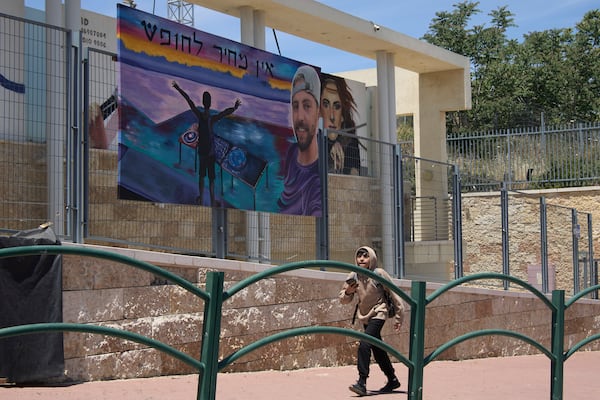A painting of Elkana Bohbot, who was abducted and brought to Gaza on Oct. 7, 2023, is hung in his family's hometown of Mevaseret Zion, Israel, Wednesday, May 7, 2025. Hebrew reads, "There is no price for freedom." (AP Photo/Maya Alleruzzo)