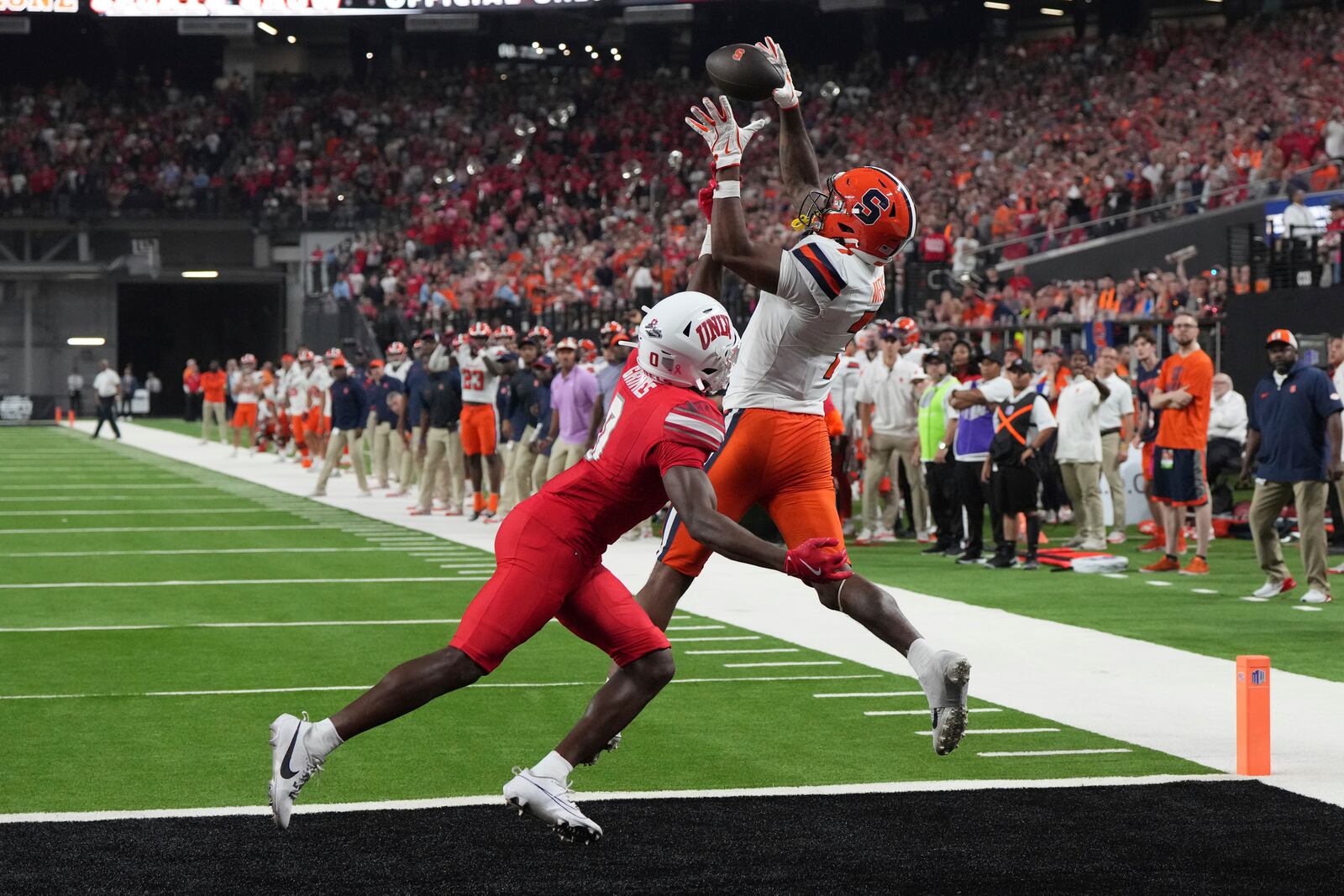 Syracuse wide receiver Jackson Meeks scores a touch down over UNLV defensive back Tony Grimes (0) in the second half during an NCAA college football game, Friday, Oct. 4, 2024, in Las Vegas. (AP Photo/Rick Scuteri)