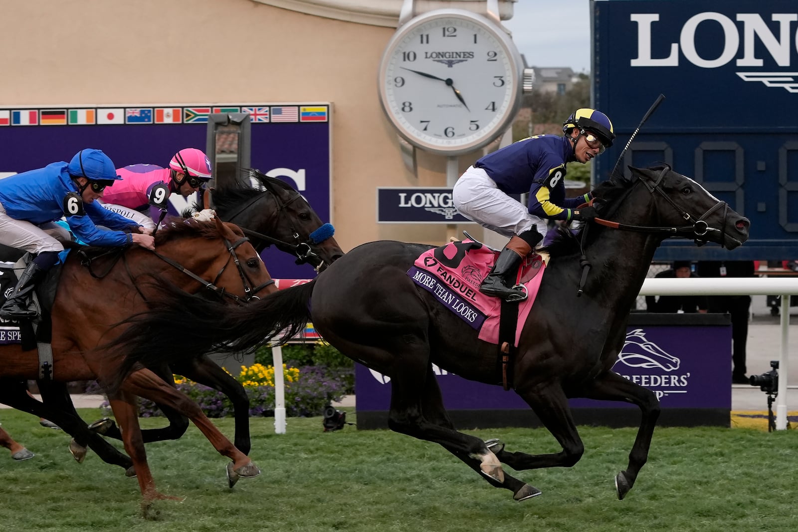 Jose Ortiz rides More Than Looks, right, to victory in the Breeders' Cup Mile horse race in Del Mar, Calif., Saturday, Nov. 2, 2024. (AP Photo/Gregory Bull)