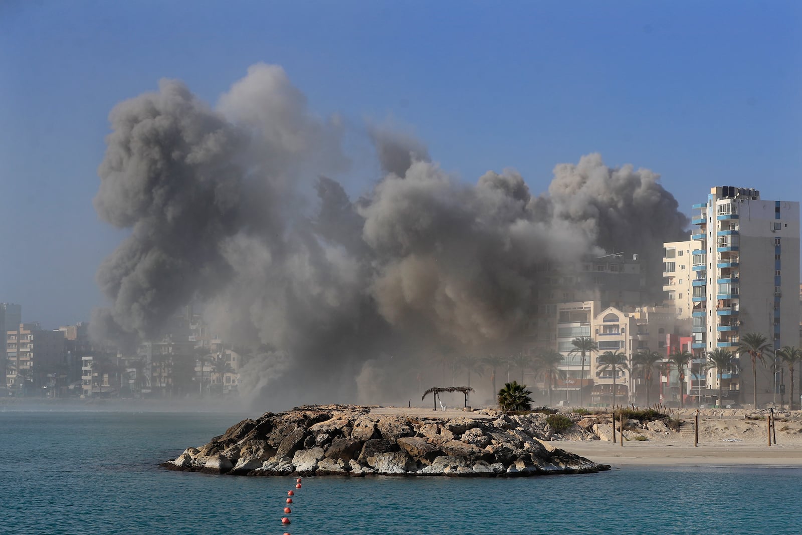 Smoke rises from buildings hit in Israeli airstrikes in Tyre, southern Lebanon, Monday, Oct. 28, 2024. (AP Photo/Mohammad Zaatari)