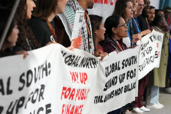 Activists participate in a demonstration for climate finance at the COP29 U.N. Climate Summit, Wednesday, Nov. 20, 2024, in Baku, Azerbaijan. (AP Photo/Peter Dejong)