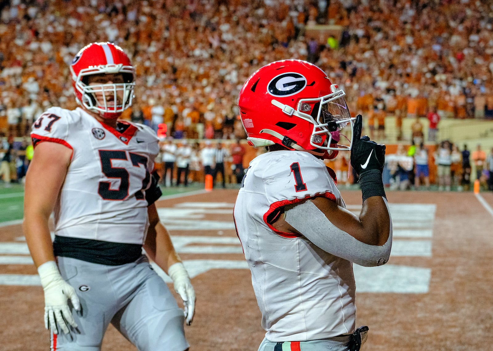 Georgia running back Trevor Etienne (1) celebrates his touchdown run against Texas as Georgia offensive lineman Monroe Freeling (57) looks on during the first half of an NCAA college football game in Austin, Texas, Saturday, Oct. 19, 2024. (AP Photo/Rodolfo Gonzalez)