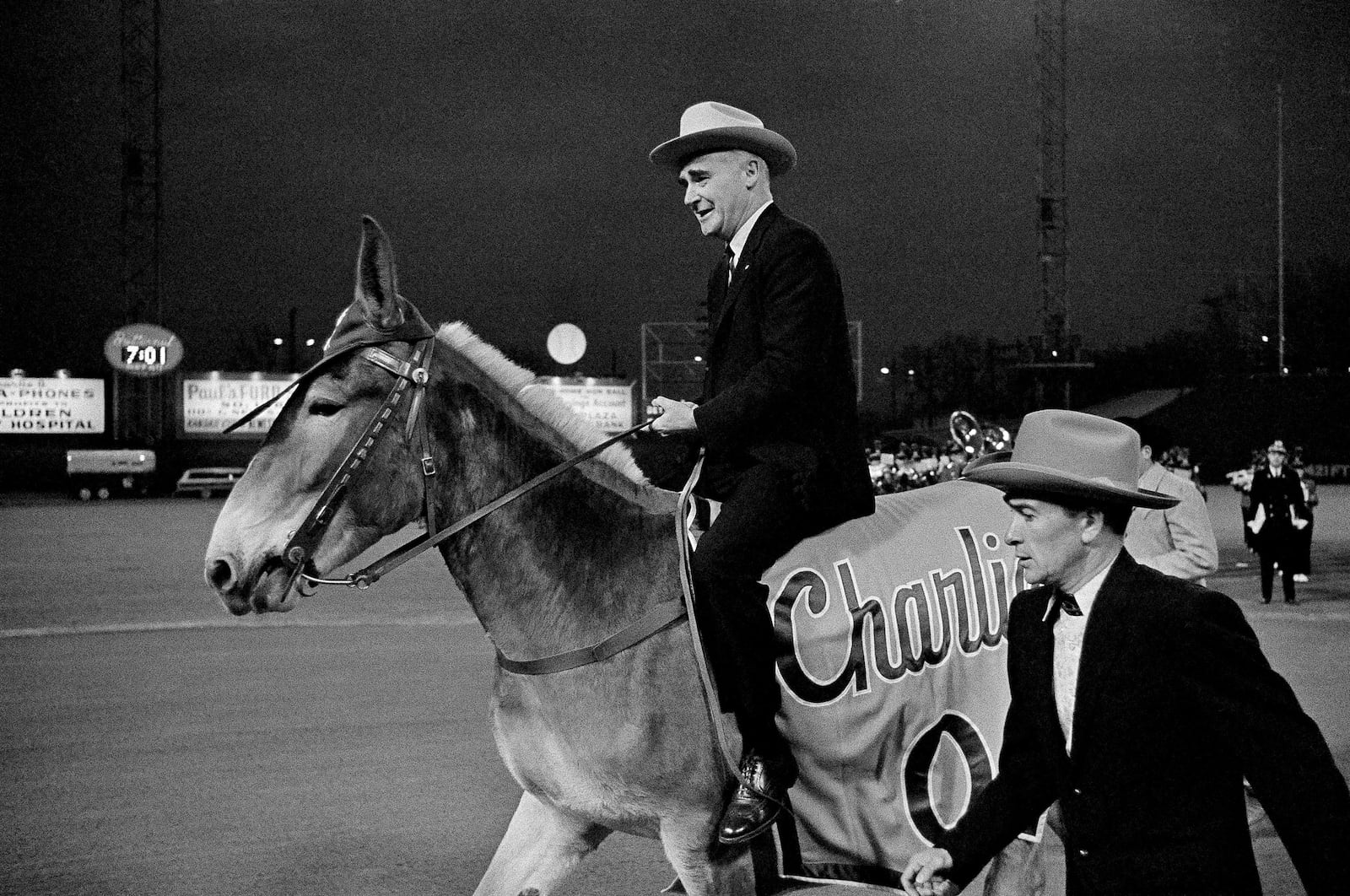 FILE - Kansas City Athletics owner Charlie Finley sits astride the team's mascot, "Charlie O," for a short ride during pre-game ceremonies at the Detroit-Kansas City opening game of the American League baseball season in Kansas City's Municipal Stadium, April 12, 1965. (AP Photo/William Straeter, File)