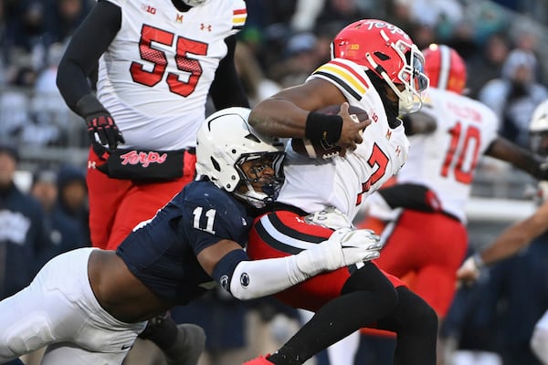 Penn State defensive end Abdul Carter (11) sacks Maryland quarterback MJ Morris (7) during the first quarter of an NCAA college football game, Saturday, Nov. 30, 2024, in State College, Pa. (AP Photo/Barry Reeger)