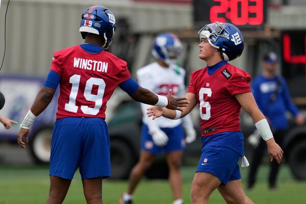 New York Giants quarterbacks Jameis Winston, left, greets Jaxson Dart during an NFL football practice in East Rutherford, N.J., Wednesday, May 28, 2025. (AP Photo/Seth Wenig)