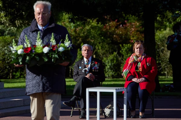 World War II D-Day veteran and Penobscot Elder from Maine, Charles Norman Shay, center, and Marie Pacale Legrand during a D-Day 76th anniversary ceremony at the Normandy American Cemetery in Colleville-sur-Mer, Normandy, France, June 6, 2020. (AP Photo/Virginia Mayo)