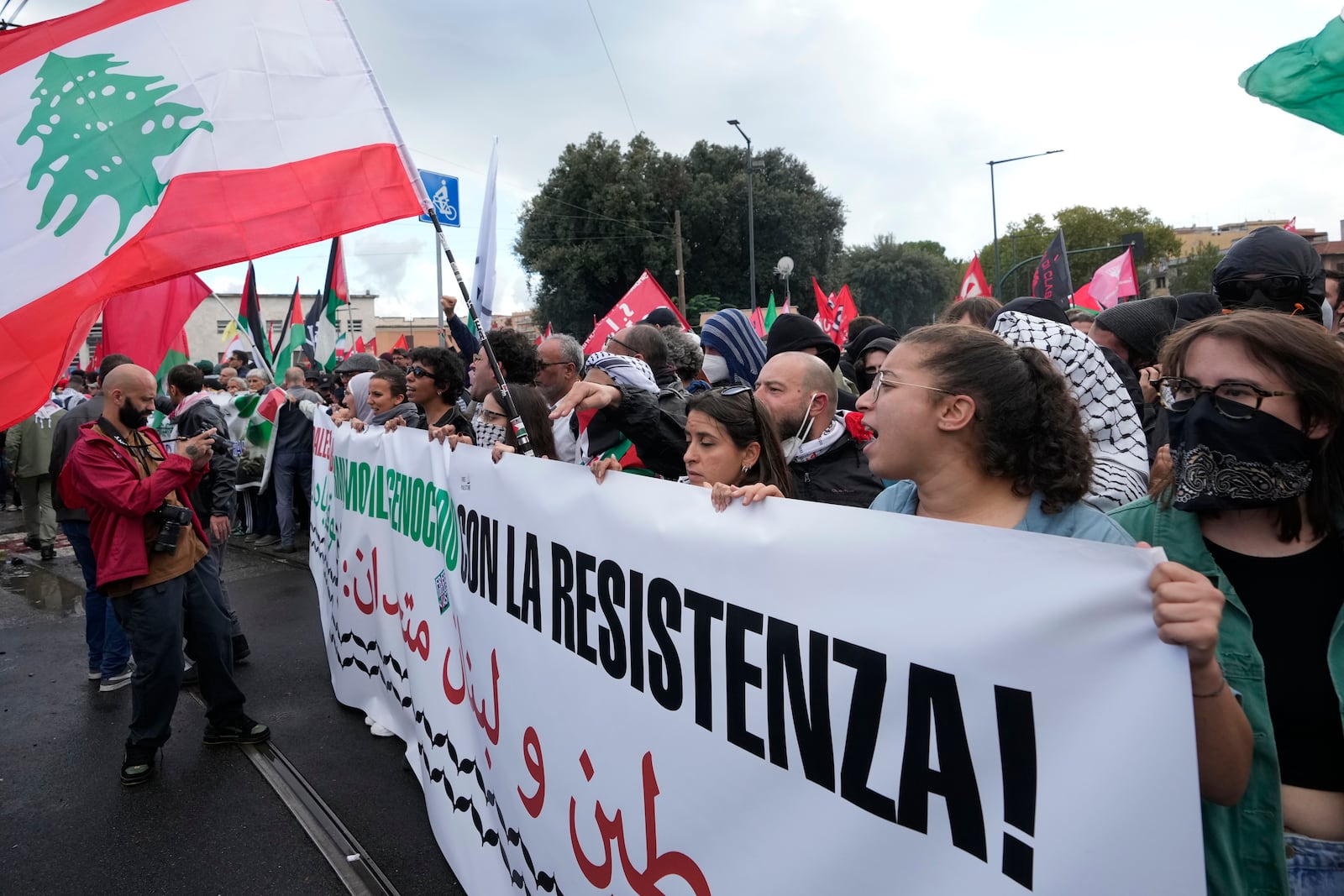 People attend at a protest in Rome, Saturday, Oct. 5, 2024. Pro-palestinians people take to the street in an unauthorised march in the centre of Rome two days ahead of the first anniversary of the Oct. 7. (AP Photo/Andrew Medichini)