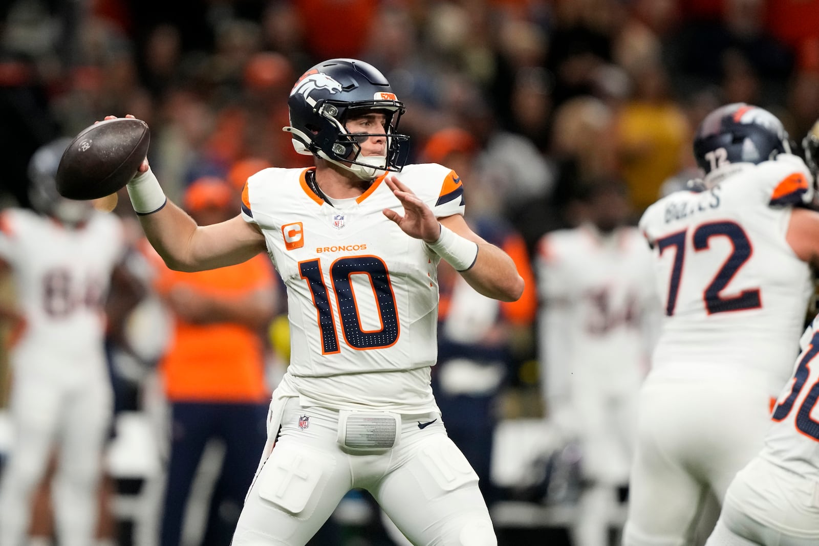 Denver Broncos quarterback Bo Nix throws a pass during the first half of an NFL football game against the New Orleans Saints, Thursday, Oct. 17, 2024, in New Orleans. (AP Photo/Gerald Herbert)