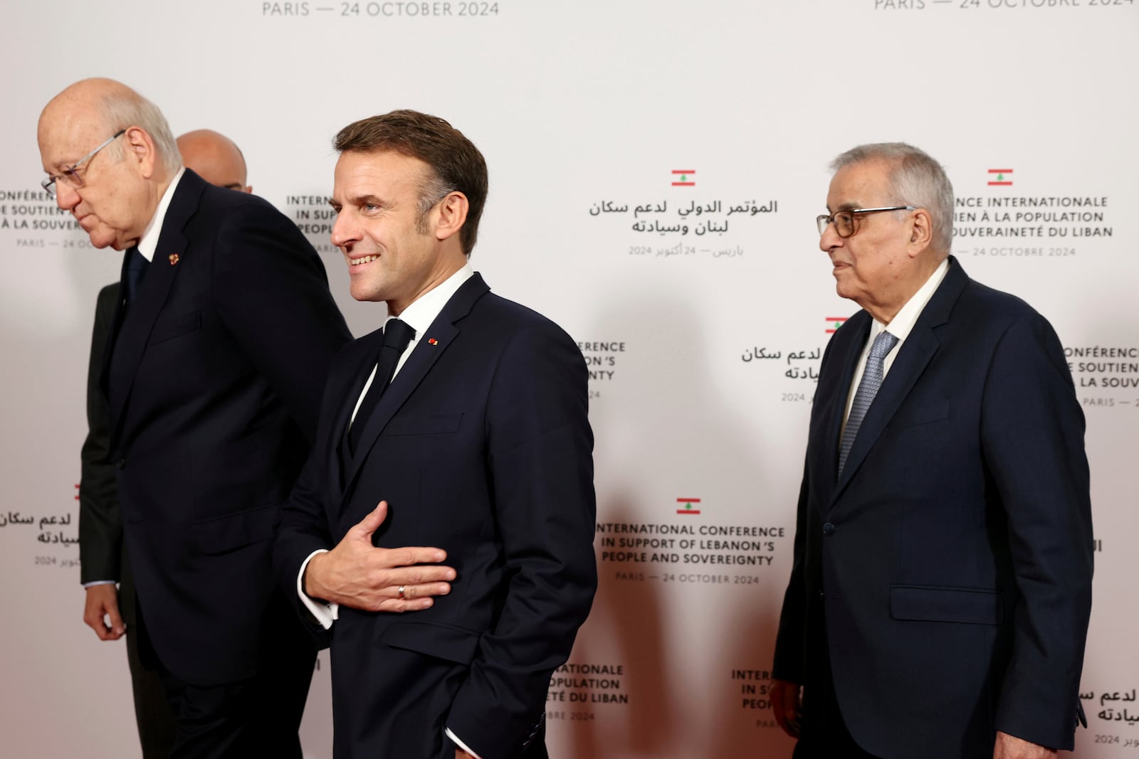 France's President Emmanuel Macron reacts next to Lebanon's Prime Minister caretaker Prime Minister Najib Mikati, left, and Lebanon's Minister of Foreign Affairs Abdallah Bou Habibas they arrive for an international press conference in support of Lebanon, in Paris, Thursday, Oct.24, 2024. (Alain Jocard, Pool via AP)