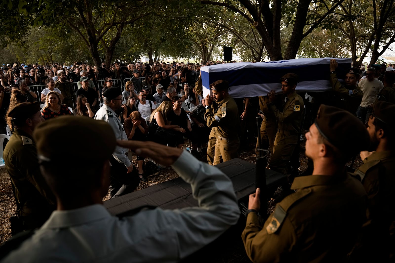 Israeli soldiers carry the flagged-covered coffin of Sgt. Amitai Alon, killed by a Hezbollah drone attack, during his funeral near Ramot Naftali, Israel, Monday, Oct. 14, 2024. (AP Photo/Leo Correa)