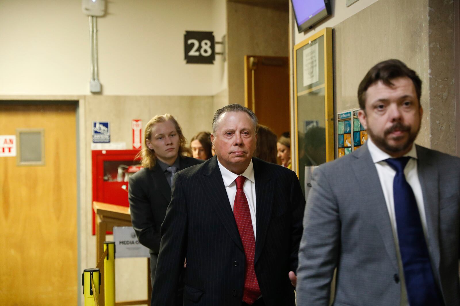 Tim Oliver Lee, right, brother of Cash App founder Bob Lee; Rick Lee, center, father of Bob Lee, Krista Lee, and other family members leave Department 28 at the Hall of Justice on the first day of the murder trial of Nima Momeni, Monday, Oct. 14, 2024, in San Francisco,. (Lea Suzuki/San Francisco Chronicle via AP)