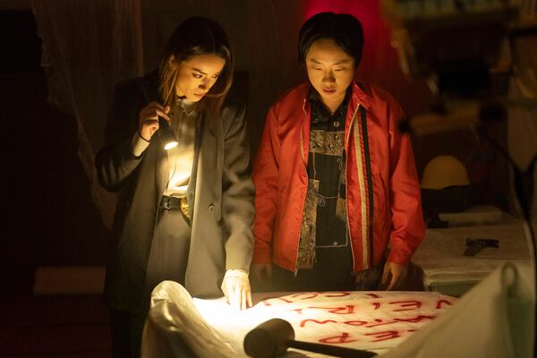 This image released by Hulu shows Chloe Bennet, left, and Jimmy O. Yang in a scene from the series "Interior Chinatown." (Mike Taing/Hulu via AP)