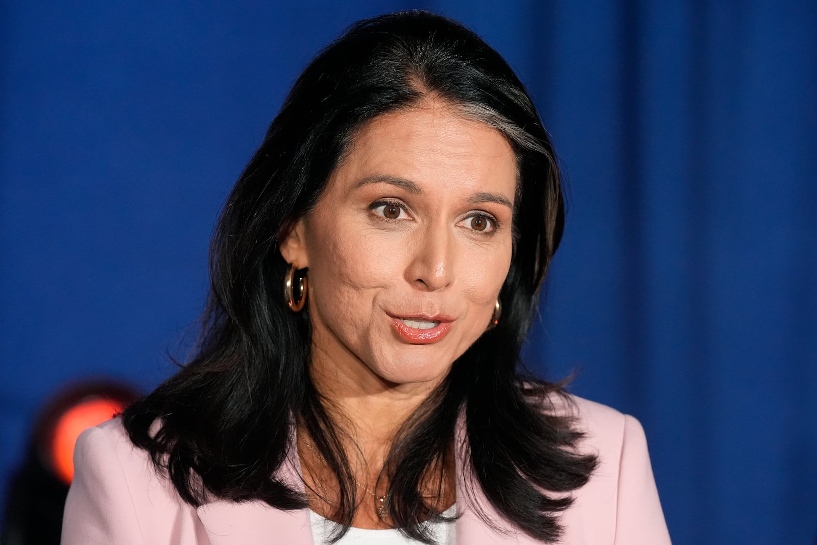 Former Democratic Rep. Tulsi Gabbard answers a question as she speaks to the media after a campaign event for Republican presidential nominee former President Donald Trump, Saturday, Sept. 14, 2024, in Glendale, Ariz. (AP Photo/Ross D. Franklin)