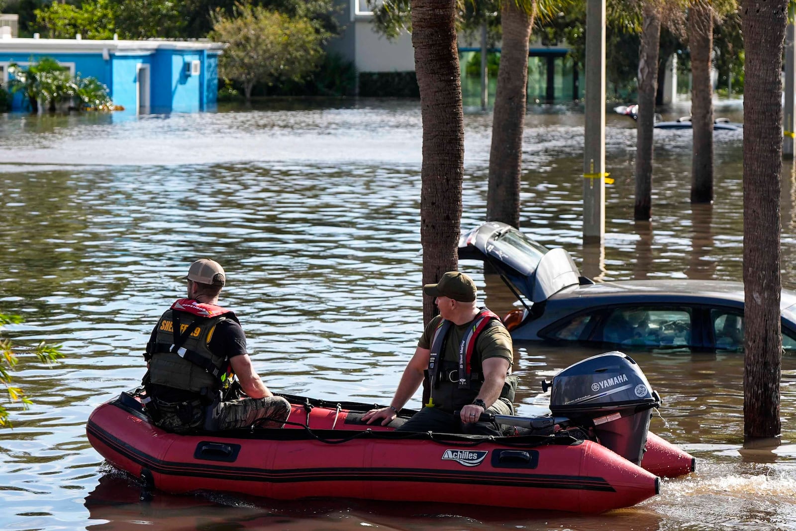 A water rescue boat moves in flood waters at an apartment complex in the aftermath of Hurricane Milton, Thursday, Oct. 10, 2024, in Clearwater, Fla. (AP Photo/Mike Stewart)