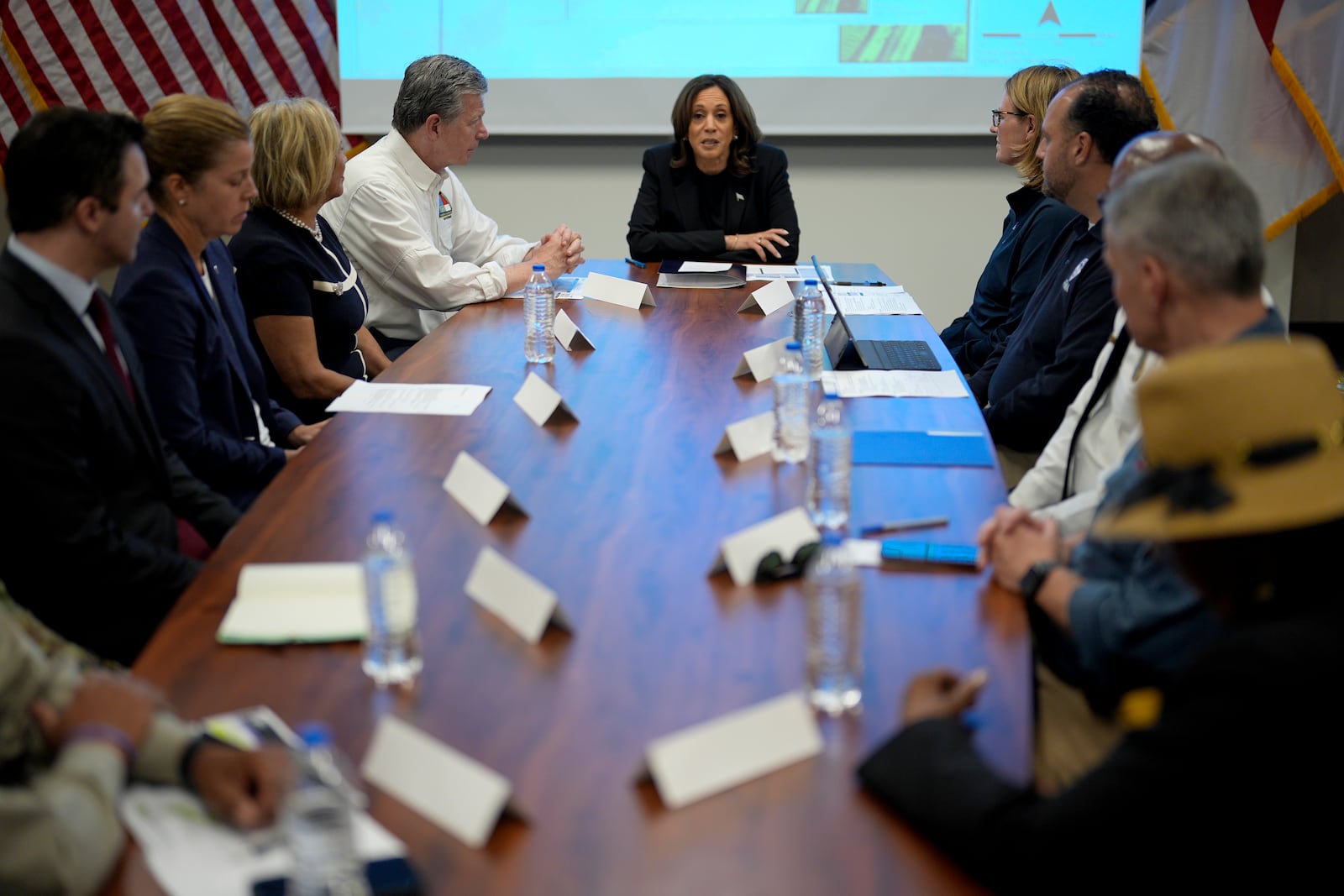 Democratic presidential nominee Vice President Kamala Harris, center right, receives a briefing from North Carolina Gov. Roy Cooper, center left, on the damage from Hurricane Helene, Saturday, October 5, 2024, in Charlotte, N.C. (AP Photo/Chris Carlson)