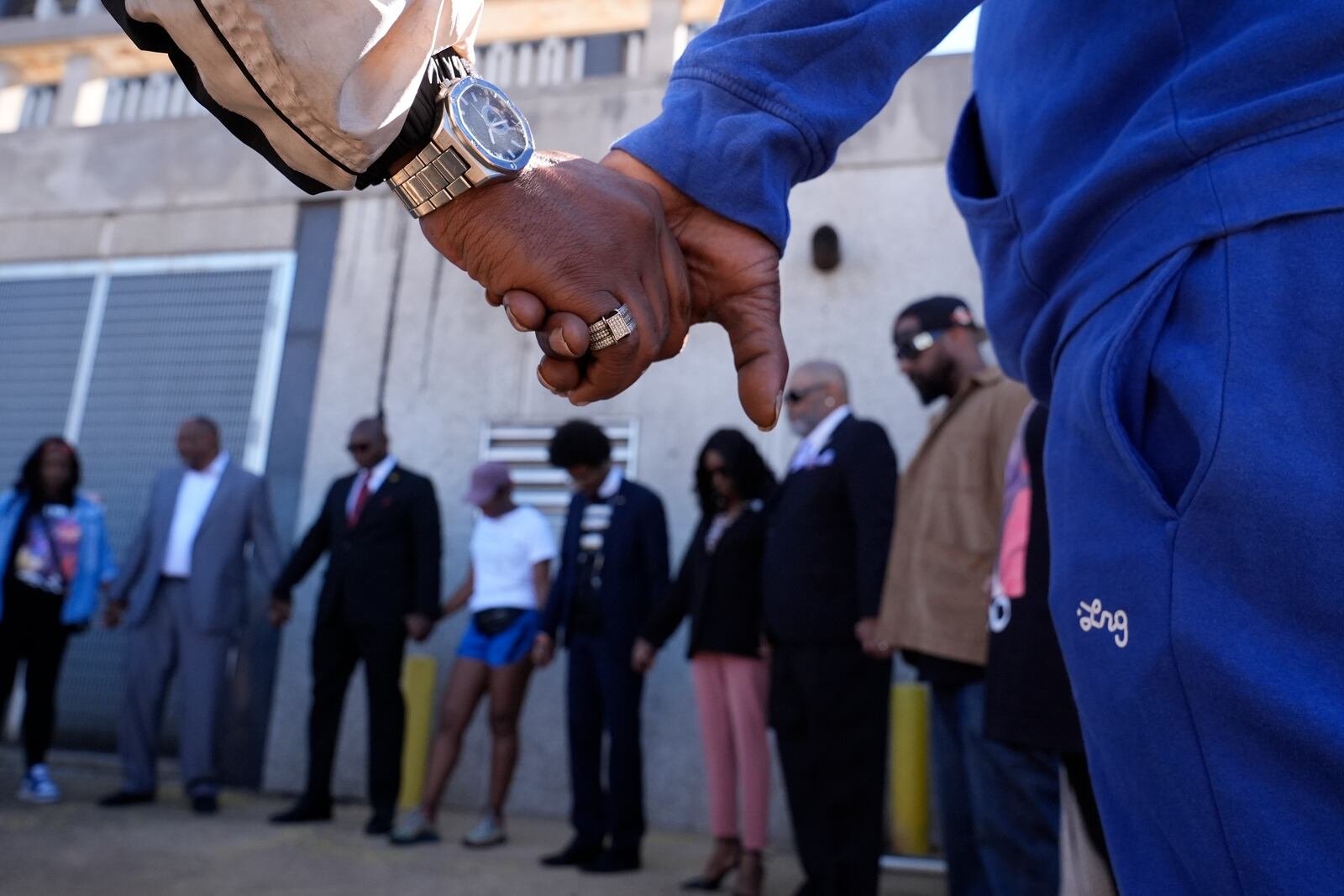 Family and friends of Tyre Nichols gather for a prayer vigil outside the federal courthouse as jury deliberations begin for the trial of three former Memphis police officers charged in the 2023 fatal beating of Nichols, Thursday, Oct. 3, 2024, in Memphis, Tenn. (AP Photo/George Walker IV)