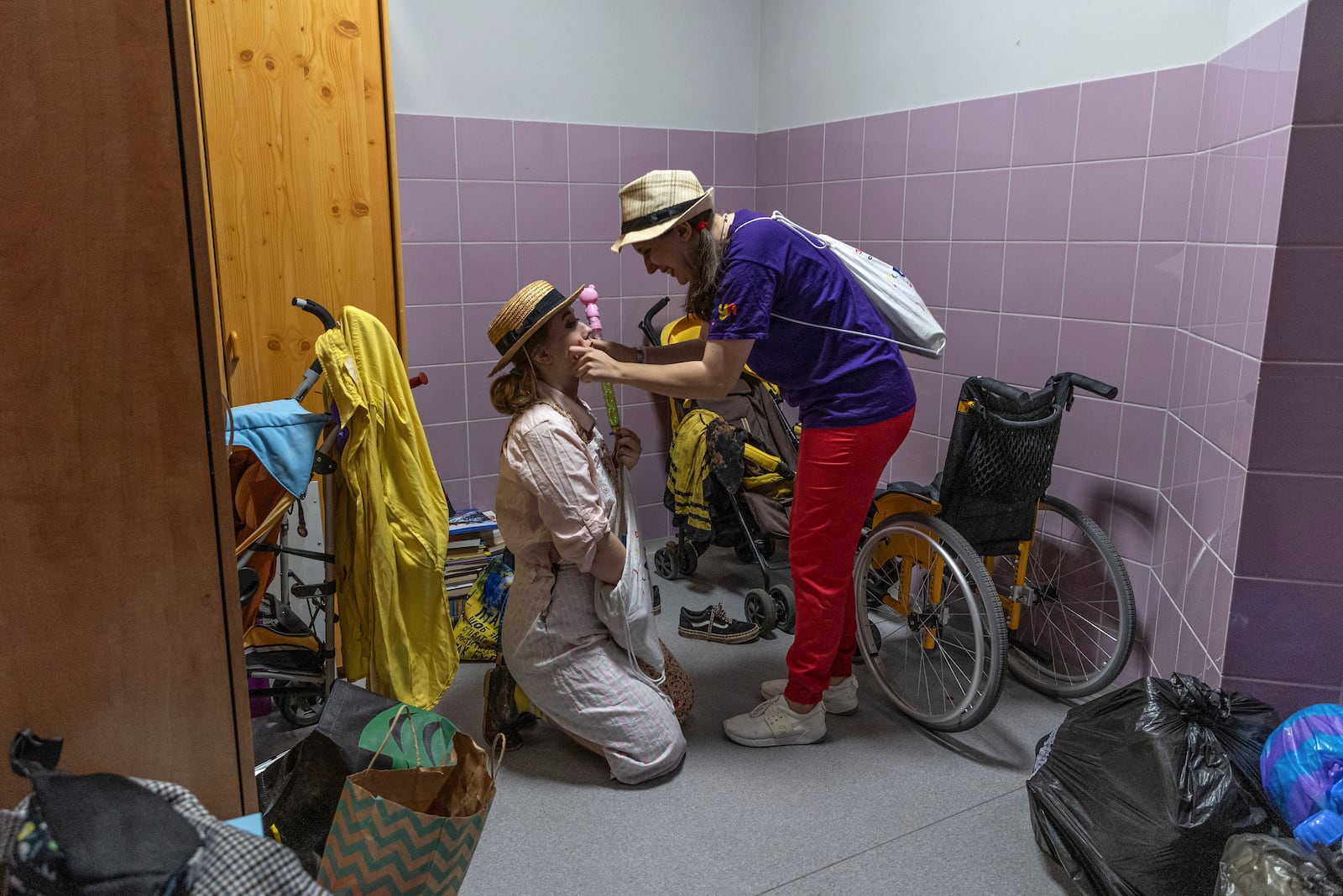 Vladyslava Kulinich, right, Tetiana Nosova, who have the clown names Lala and Zhuzha, prepare to perform at Okhmatdyt children's hospital in Kyiv, Ukraine, Thursday Sept. 19, 2024. (AP Photo/Anton Shtuka)