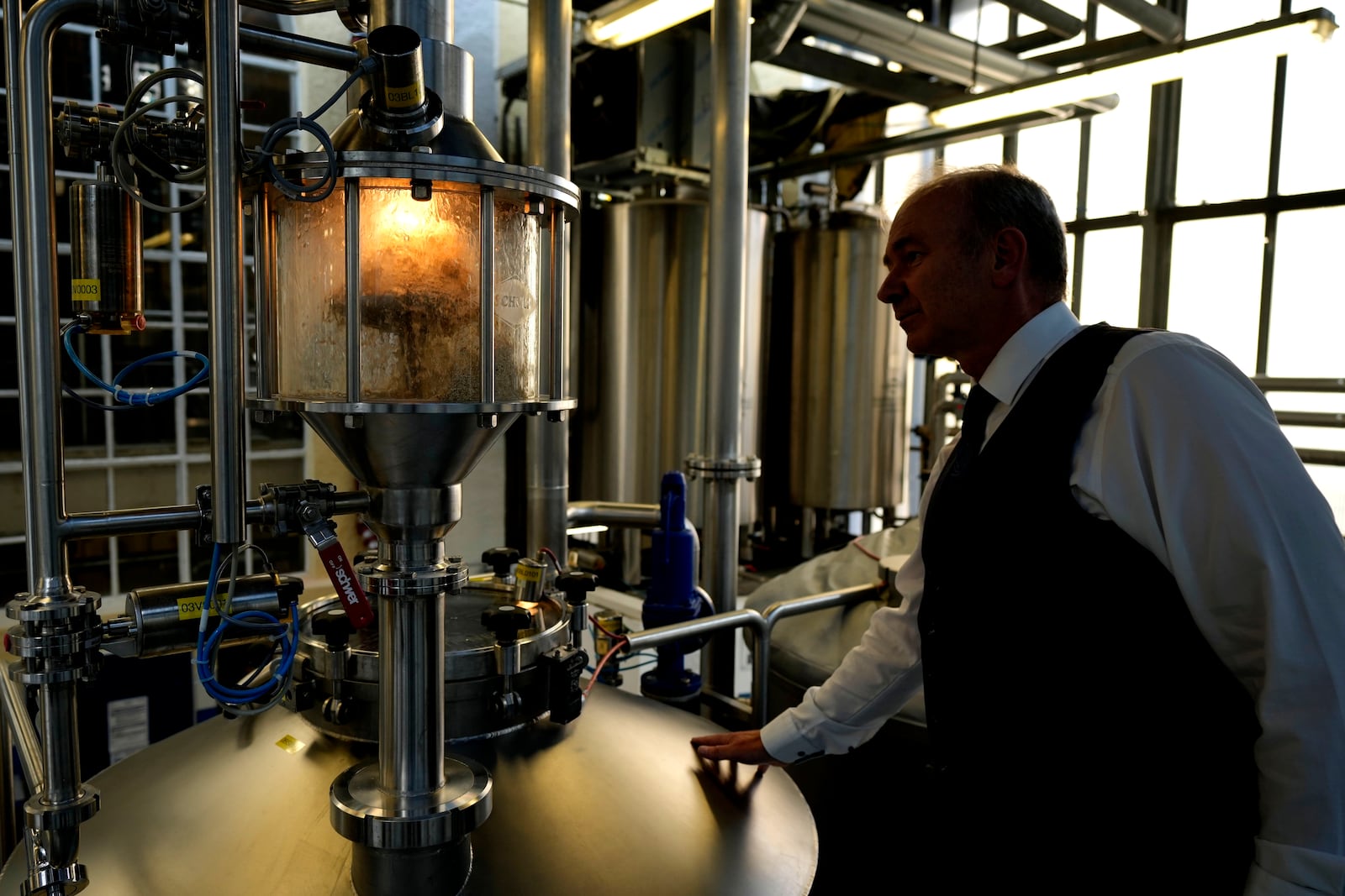 Professor Thomas Becker checks the brewery plant in Freising, Germany, Thursday, Sept. 19, 2024. (AP Photo/Matthias Schrader)