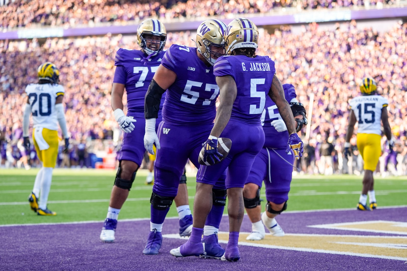 Washington wide receiver Giles Jackson (5) celebrates his touchdown with offensive lineman Enokk Vimahi (57) against Michigan during the first half of an NCAA college football game Saturday, Oct. 5, 2024, in Seattle. (AP Photo/Lindsey Wasson)