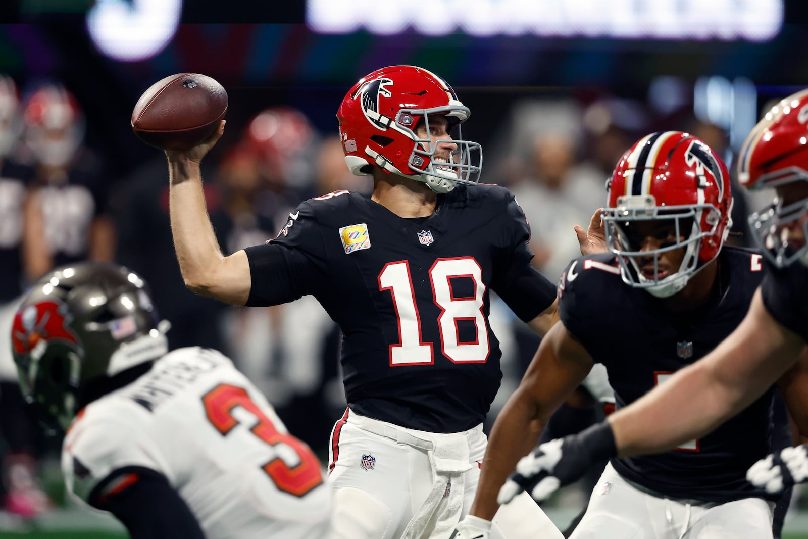 Atlanta Falcons quarterback Kirk Cousins throws a pass against the Tampa Bay Buccaneers during the first half of an NFL football game Thursday, Oct. 3, 2024, in Atlanta. (AP Photo/John Bazemore)