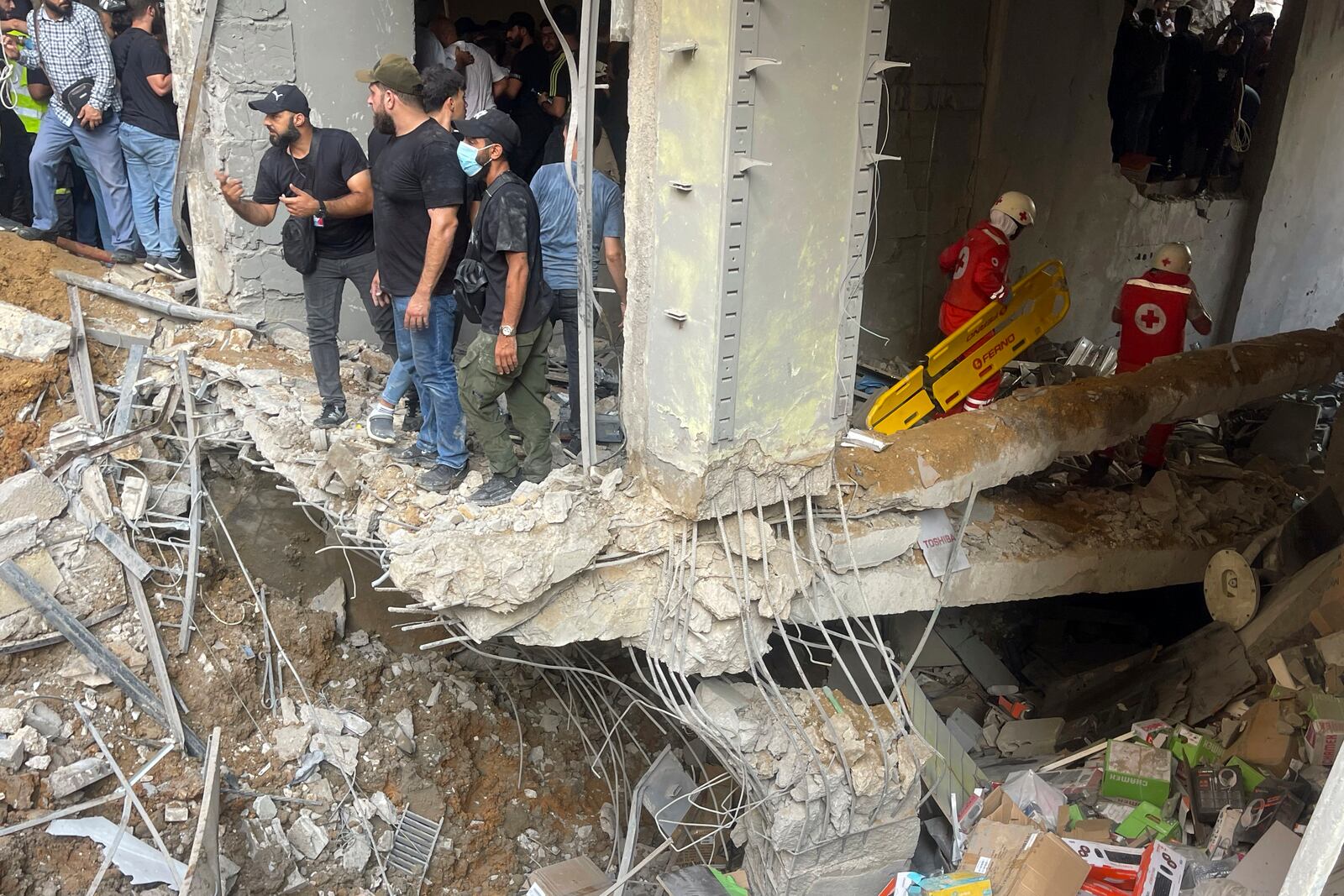 People and rescuers gather at the scene of an Israeli missile strike in the southern suburbs of Beirut, Friday, Sept. 20, 2024. (AP Photo/Bilal Hussein)