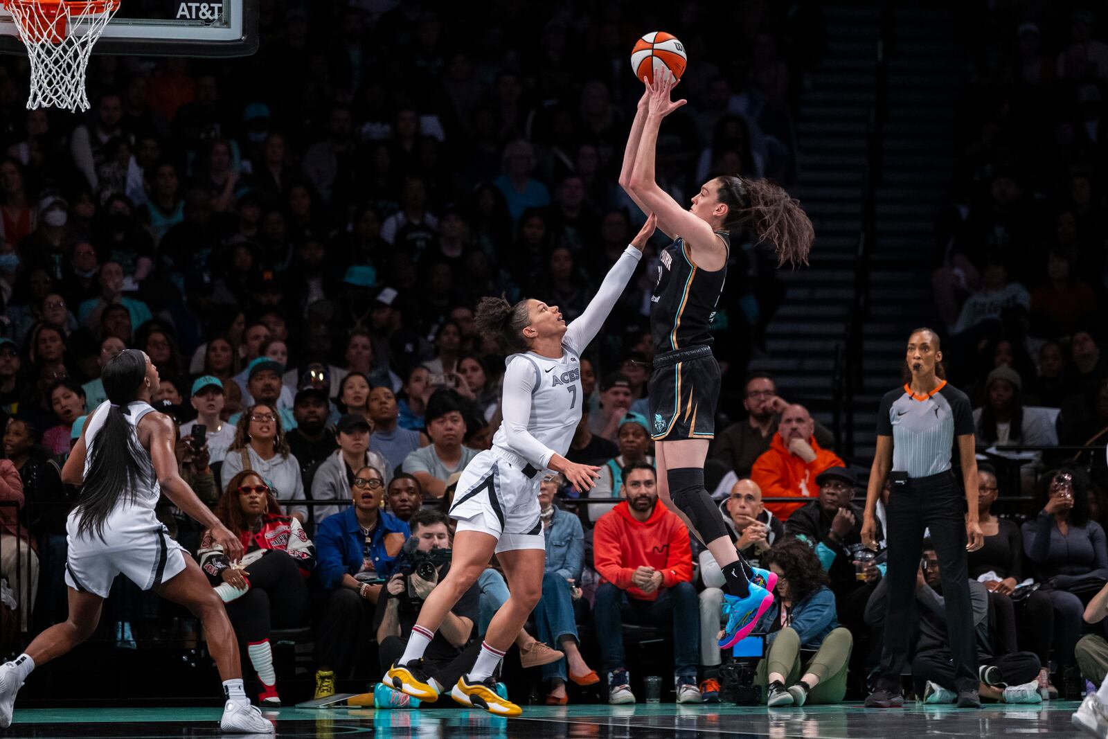 New York Liberty forward Breanna Stewart, center right, shoots over Las Vegas Aces forward Alysha Clark (7) during the second half of a WNBA basketball second-round playoff game, Sunday, Sept. 29, 2024, in New York. (AP Photo/Corey Sipkin)