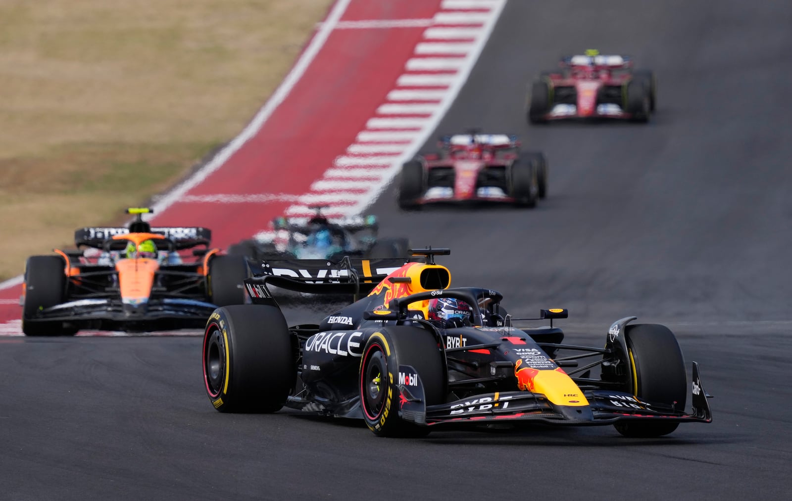 Red Bull driver Max Verstappen, of the Netherlands, leads McLaren driver Lando Norris, of Britain, through a turn during a sprint race ahead of the Formula One U.S. Grand Prix auto race at Circuit of the Americas, Saturday, Oct. 19, 2024, in Austin, Texas. (AP Photo/Eric Gay)