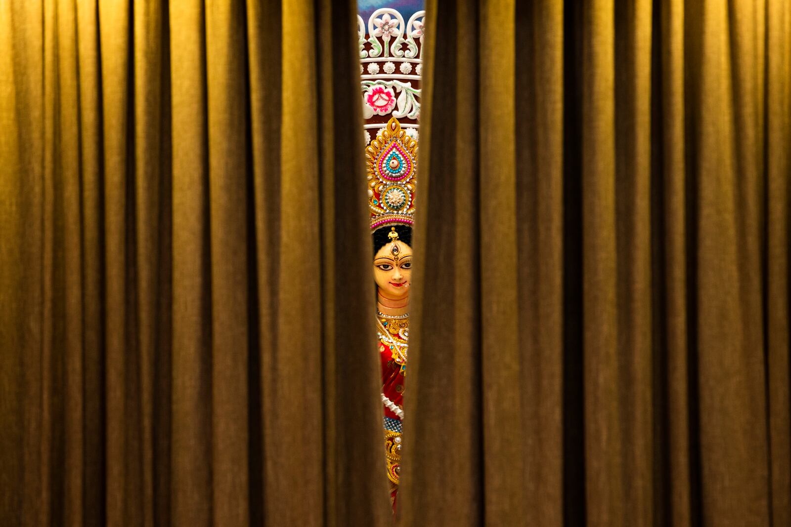 An idol of Hindu goddess Durga is seen as curtains of a tableau opens at Dhakeshwari National Temple during the Durgapuja festival in Dhaka, Bangladesh, on Oct. 10, 2024. (AP Photo/Rajib Dhar)