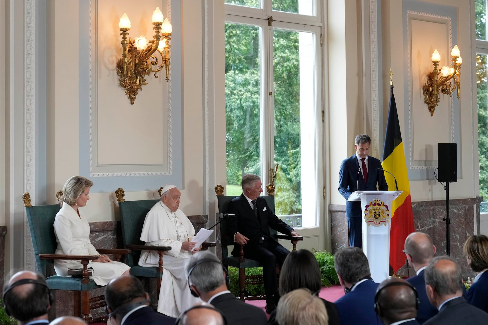 Pope Francis, Queen Mathilde and King Philippe listen to Belgium Prime Minister Alexander De Croo's address during a meeting with the authorities and the civil society in the Grande Galerie of the Castle of Laeken, Brussels, Friday, Sept. 27, 2024. (AP Photo/Andrew Medichini)