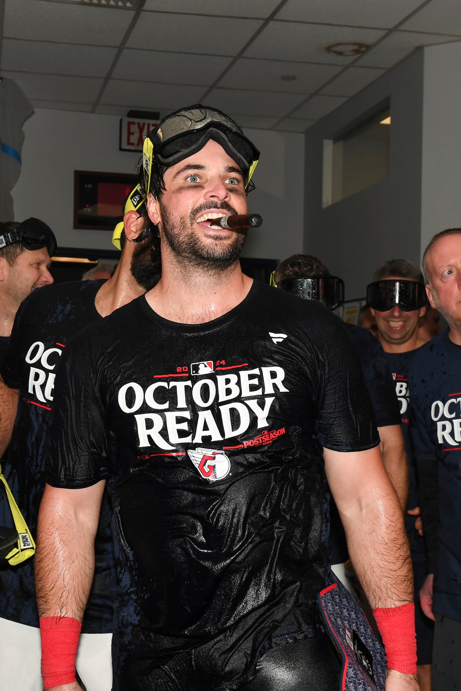 Cleveland Guardians' Austin Hedges celebrates in the clubhouse after they defeated the Minnesota Twins to clinch a baseball playoff berth, Thursday, Sept. 19, 2024, in Cleveland. (AP Photo/Nick Cammett)