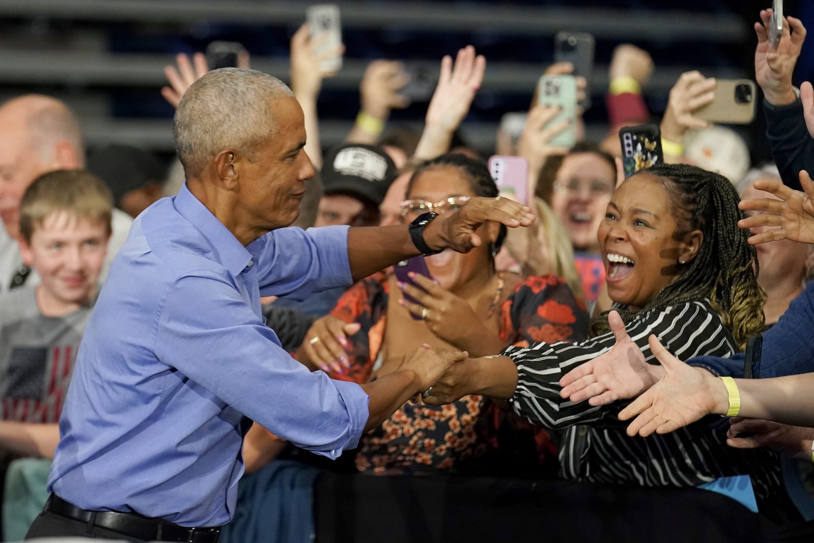 Former President Barack Obama greets attendees before speaking at a campaign rally supporting Democratic presidential nominee Vice President Kamala Harris, Thursday, Oct. 10, 2024, at the University of Pittsburgh's Fitzgerald Field House in Pittsburgh. (AP Photo/Matt Freed)